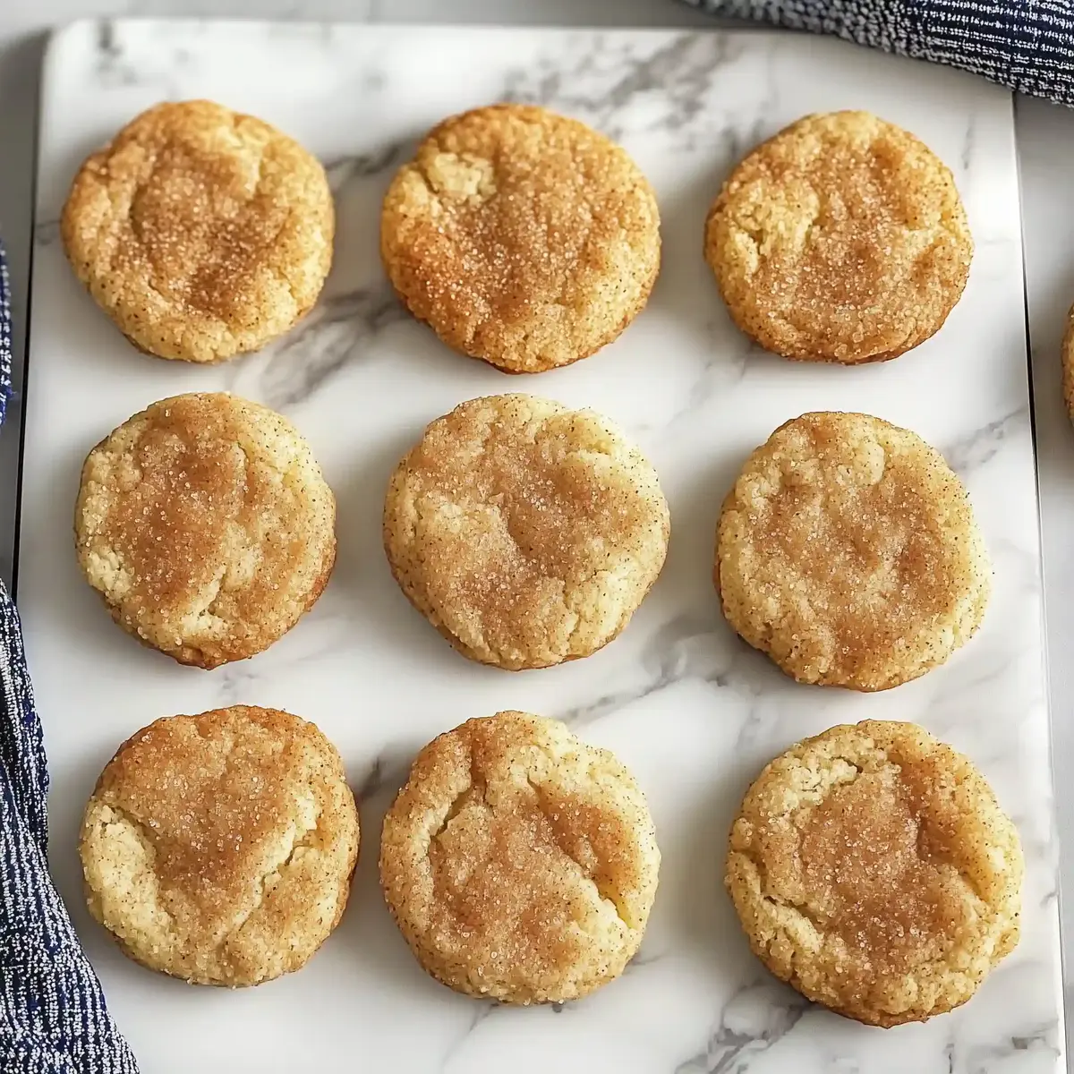 Gluten-free snickerdoodle cookies on a cooling rack.