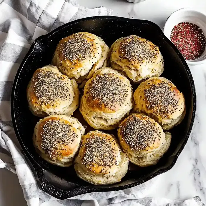 Cast iron skillet with golden biscuits and everything bagel seasoning.