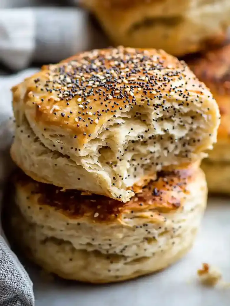 Everything bagel swim biscuits with chicken tender on a marble surface.