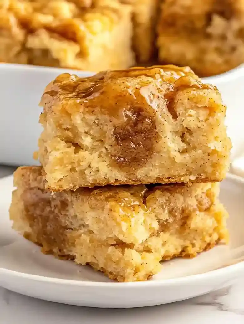 Two golden-brown Sweet Potato Butter Swim Biscuits drizzled with honey.
