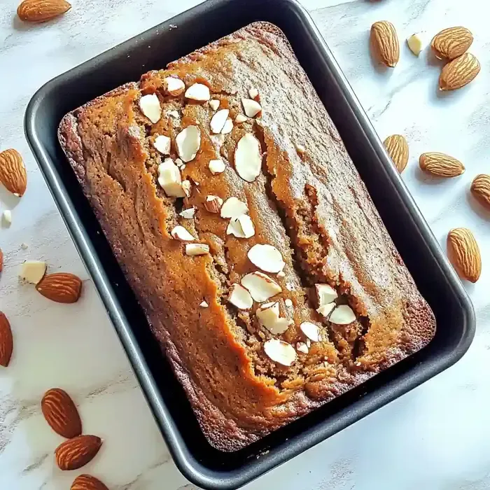 Freshly baked pumpkin bread with white chocolate and almonds on top.